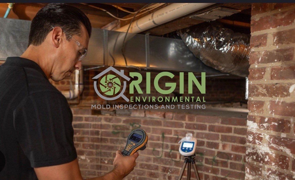 Justin Zarudny of Origin Environmental documenting conditions in a crawlspace with air sampling equipment