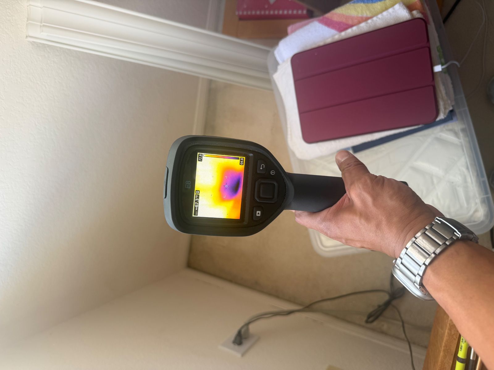 Thermal camera showing a cool spot near a closet baseboard